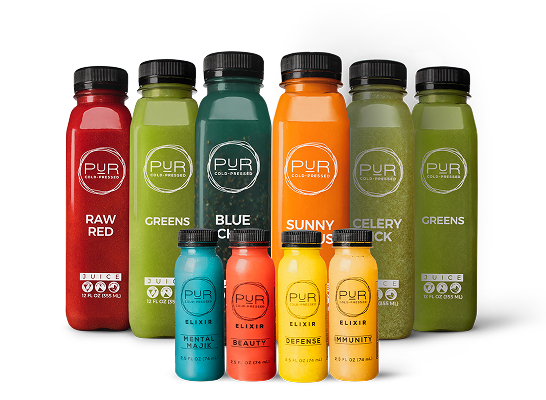 Assorted bottles of PUR cold-pressed juice and PUR wellness shots on a white background
