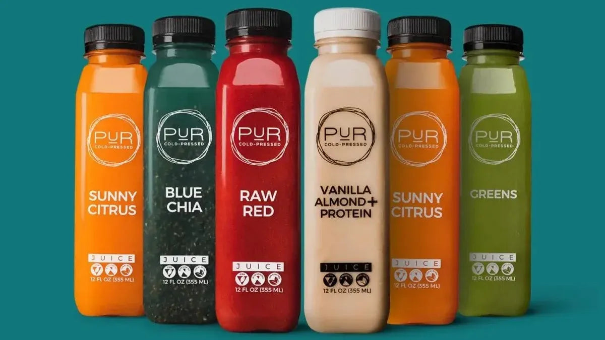 PUR cold-pressed juice and protein bottles in a colorful lineup