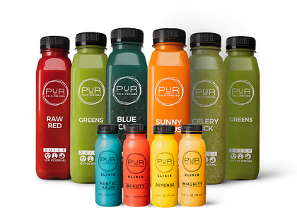 Assorted bottles of PUR cold-pressed juice and PUR wellness shots on a white background